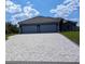 Large driveway with a patterned paver design at 2761 Newman Dr, North Port, FL 34288