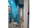 Bathroom with teal walls, vanity, and access to shower at 2761 Newman Dr, North Port, FL 34288