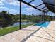 Enjoy this large pool with a screened enclosure and scenic water view at 2761 Newman Dr, North Port, FL 34288