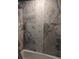 Shower with marble and hexagon tile details at 2761 Newman Dr, North Port, FL 34288