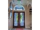 Elegant entryway with double doors, chandelier, and arched window at 2761 Newman Dr, North Port, FL 34288