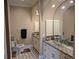 Bathroom with double vanity, glass sink and patterned tile floor at 2761 Newman Dr, North Port, FL 34288