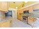 Kitchen with light wood cabinets, granite countertops, and tile flooring at 16681 Acapulco Rd, Punta Gorda, FL 33955