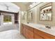 Bathroom with double sinks, view of backyard, and access to other rooms at 16681 Acapulco Rd, Punta Gorda, FL 33955