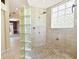 Large walk-in shower with glass block accents and tile flooring at 16681 Acapulco Rd, Punta Gorda, FL 33955