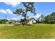 Landscaped yard with large tree and spacious lawn at 16681 Acapulco Rd, Punta Gorda, FL 33955