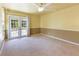 Bedroom with carpet flooring, ceiling fan and doors leading to the patio at 16681 Acapulco Rd, Punta Gorda, FL 33955