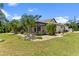 Single-story home with covered patio, landscaped yard, and palm trees at 16681 Acapulco Rd, Punta Gorda, FL 33955