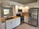 Modern kitchen featuring stainless steel appliances and butcher block countertops at 1525 Heberling Ave, North Port, FL 34288