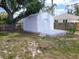 White shed with a gray deck in the backyard at 1525 Heberling Ave, North Port, FL 34288