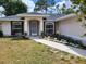 Single-story home with landscaped yard and walkway at 1525 Heberling Ave, North Port, FL 34288