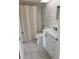 Updated bathroom with white vanity and bathtub at 1525 Heberling Ave, North Port, FL 34288