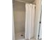 Clean shower stall with white tile and a white shower curtain at 1525 Heberling Ave, North Port, FL 34288