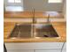 Modern stainless steel kitchen sink with butcher block countertops at 1525 Heberling Ave, North Port, FL 34288
