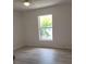 Well-lit bedroom with vinyl plank flooring and a window at 1525 Heberling Ave, North Port, FL 34288