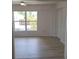 Spacious bedroom featuring vinyl plank flooring and large window at 1525 Heberling Ave, North Port, FL 34288