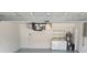 Garage laundry room with washer, dryer and shelving at 1525 Heberling Ave, North Port, FL 34288