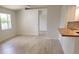 Bright living room with light flooring and kitchen view at 1525 Heberling Ave, North Port, FL 34288