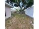 Backyard with large tree and wooden fence at 1525 Heberling Ave, North Port, FL 34288