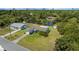 Aerial view of the property showcasing the home, spacious yard, shed, and surrounding neighborhood at 1585 Harmony Dr, Port Charlotte, FL 33952