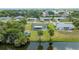 Aerial view featuring the house, shed, trees, and nearby waterway at 1585 Harmony Dr, Port Charlotte, FL 33952