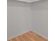 Simple walk-in closet with wood laminate flooring and white walls at 1585 Harmony Dr, Port Charlotte, FL 33952