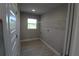 Bright laundry room with a large window, utility sink, and a wire shelf for storage at 8124 Welsford Rd, Port Charlotte, FL 33981