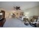 A bright living room is showcased with comfortable seating, ceiling fan, and adjoining dining area at 4000 Bal Harbor Blvd # 214, Punta Gorda, FL 33950