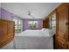 A serene main bedroom with a built-in wardrobe, plush white bedding, and view of the screened lanai at 4000 Bal Harbor Blvd # 214, Punta Gorda, FL 33950