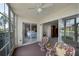 A relaxing lanai with wicker furniture, perfect for enjoying views of the adjacent bedroom and canal at 4000 Bal Harbor Blvd # 214, Punta Gorda, FL 33950