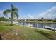 Peaceful waterfront view with boats docked and palm trees at 4000 Bal Harbor Blvd # 214, Punta Gorda, FL 33950