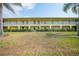 Two-story yellow building with balconies and lawn at 4000 Bal Harbor Blvd # 214, Punta Gorda, FL 33950