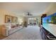 Bright living room with comfy seating, large TV, and sliding glass doors leading to a patio at 4000 Bal Harbor Blvd # 214, Punta Gorda, FL 33950