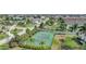 Community tennis court surrounded by tropical landscaping at 4000 Bal Harbor Blvd # 214, Punta Gorda, FL 33950