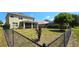 Large backyard with chain link fence and established trees at 10034 Winding River Rd, Punta Gorda, FL 33950