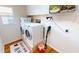 Bright laundry room with washer, dryer, and ample storage at 10034 Winding River Rd, Punta Gorda, FL 33950