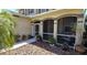 Inviting front porch with screened enclosure and landscaping at 10034 Winding River Rd, Punta Gorda, FL 33950