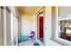 Inviting entryway with red door and small seating area at 10034 Winding River Rd, Punta Gorda, FL 33950