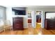 Main bedroom with hardwood floors, large TV, and ensuite bathroom at 10034 Winding River Rd, Punta Gorda, FL 33950