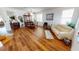 Living room with hardwood floors, beige couch, and dining area at 10034 Winding River Rd, Punta Gorda, FL 33950
