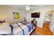 Bedroom with hardwood floors, a full-size bed, and a walk-in closet at 10034 Winding River Rd, Punta Gorda, FL 33950