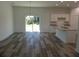 Bright dining area with wood-look floors and access to sliding glass doors at 3567 Bahnson St, North Port, FL 34288