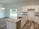 Modern kitchen with white shaker cabinets, granite countertops, and island at 3567 Bahnson St, North Port, FL 34288