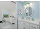 Bright bathroom with single sink vanity and framed mirror with two-door entry at 4224 Oak Terrace Cir, Port Charlotte, FL 33953