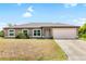 One-story home with brown stucco siding and attached garage at 4530 Irdell Ter, North Port, FL 34288