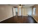 Well-lit bedroom featuring dark wood-look floors and access to another room at 4530 Irdell Ter, North Port, FL 34288