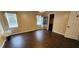 Bright bedroom with dark wood-look floors, window blinds, and a spacious layout at 4530 Irdell Ter, North Port, FL 34288