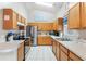 Well-equipped kitchen with wood cabinets and stainless steel appliances at 4530 Irdell Ter, North Port, FL 34288