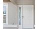 White front door with glass sidelight at 4530 Irdell Ter, North Port, FL 34288