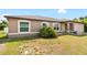 Tan house with a two-car garage and neatly kept lawn at 4530 Irdell Ter, North Port, FL 34288
